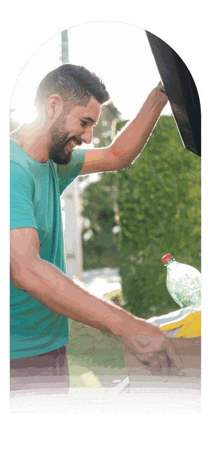 Resident sorting a bottle into a recycling bin